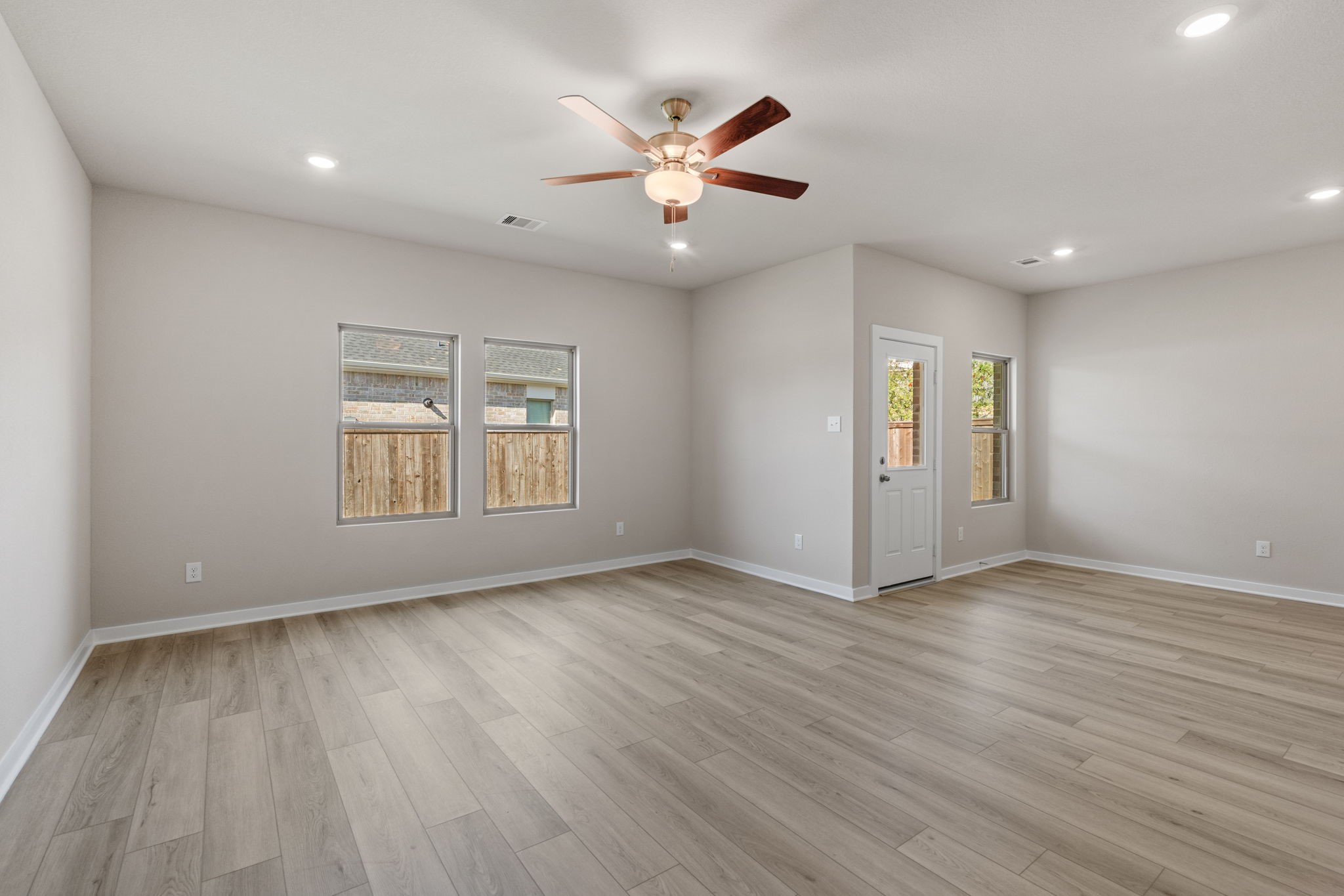 12015 Moonlight Path Drive Conroe, TX 77304 - Photo 11 of 31 wooden floor in an empty room with a window