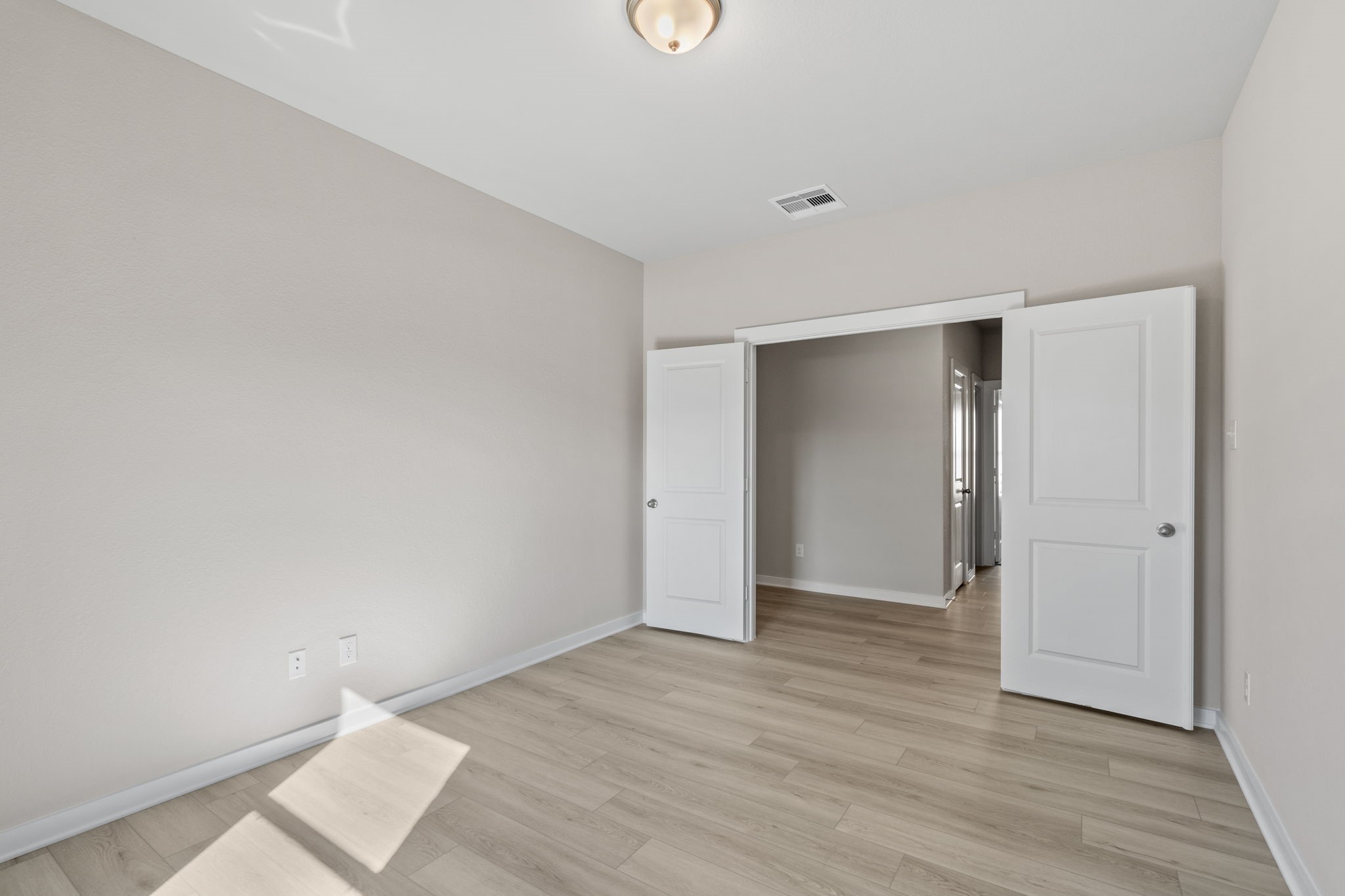 12015 Moonlight Path Drive Conroe, TX 77304 - Photo 14 of 31 a view of an empty room with wooden floor and a window