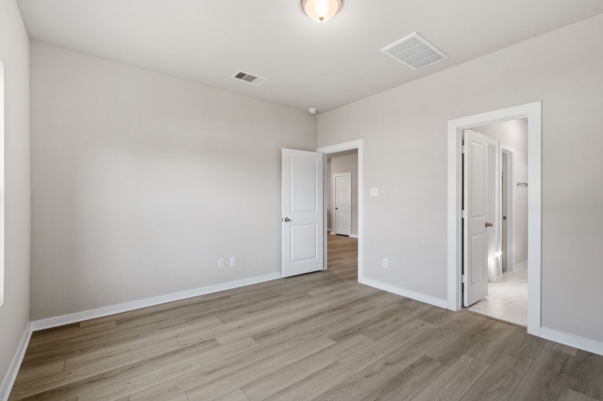 12015 Moonlight Path Drive Conroe, TX 77304 - Photo 17 of 31 a view of an empty room with wooden floor
