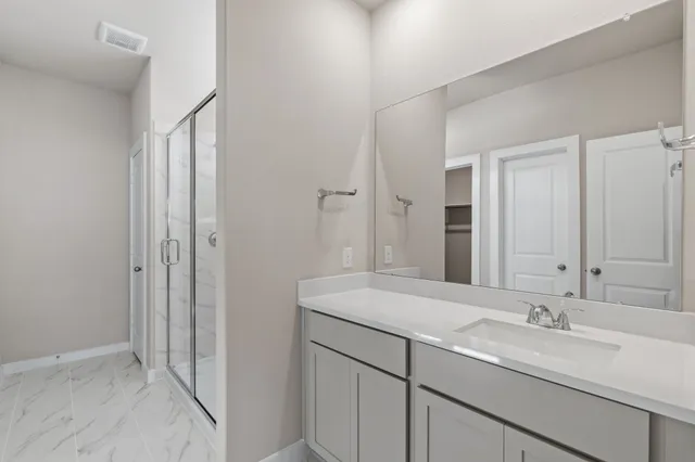a bathroom with a double vanity sink and mirror