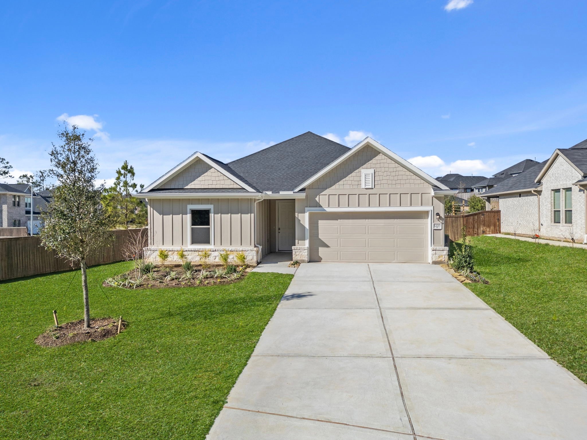 12015 Moonlight Path Drive Conroe, TX 77304 - Photo 28 of 31 a front view of a house with a garden and yard