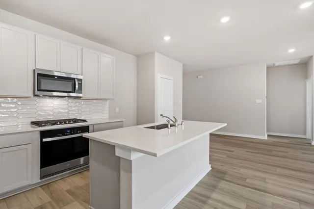 a kitchen that has a sink and a stove in it