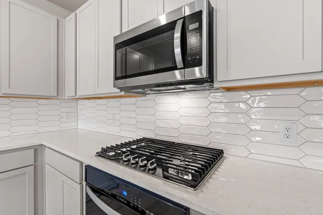 a stove top oven sitting inside of a kitchen