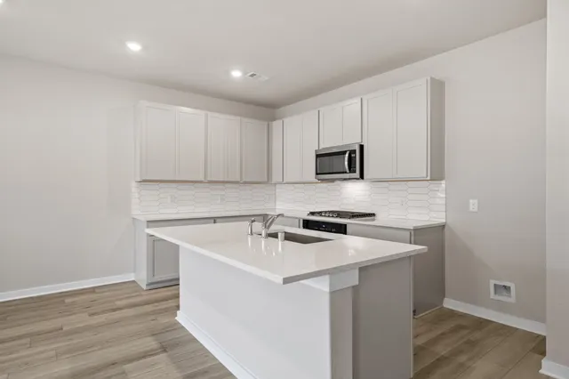 a utility room with cabinets washer and dryer
