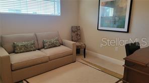 650 Golden Gate Point, Unit 301 Sarasota, FL 34236 - Photo 27 of 31 a living room with furniture and a window