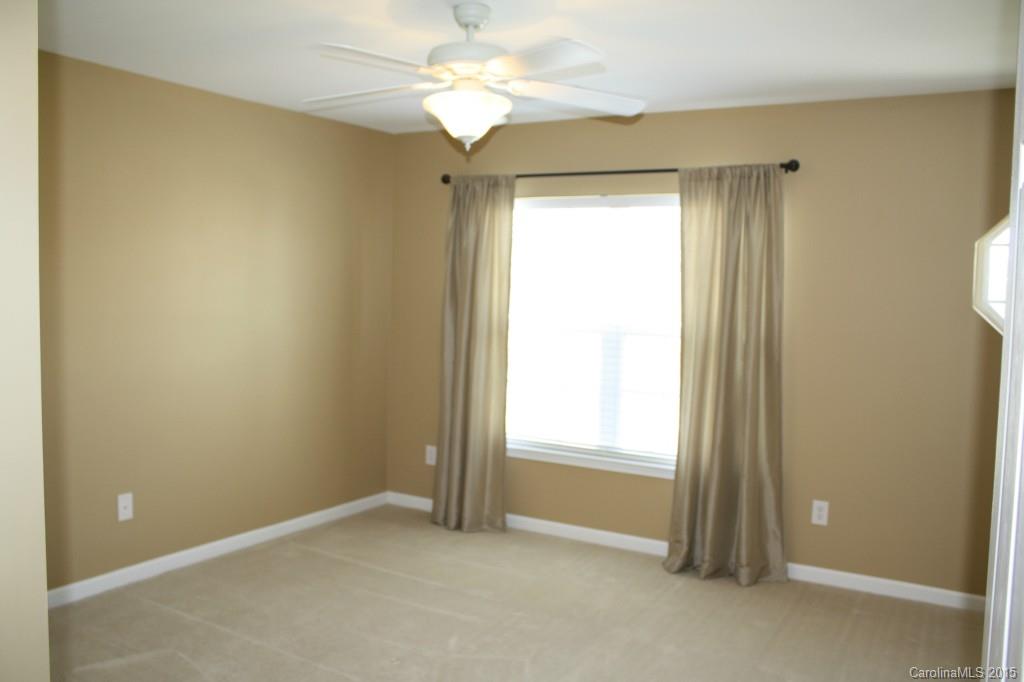 6418 Hermsley Road Charlotte, NC 28278 - Photo 15 of 22 an empty room with a window and a fan