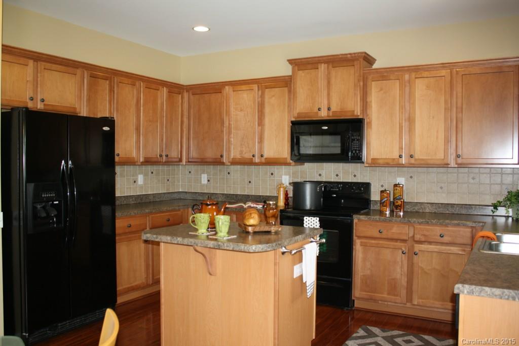 6418 Hermsley Road Charlotte, NC 28278 - Photo 4 of 22 a kitchen with a stove a microwave a sink and cabinets