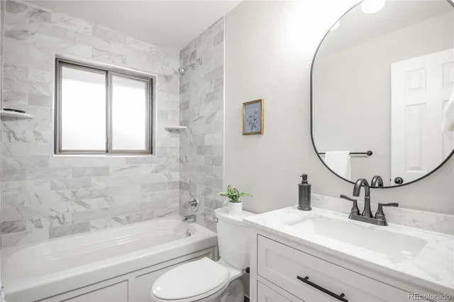 a bathroom with a sink toilet and bathtub