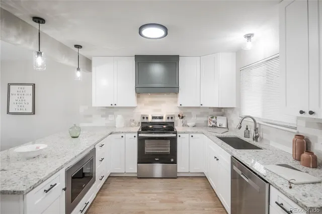 a kitchen with a sink stove and cabinets