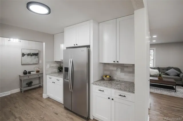 a kitchen with a refrigerator sink and stove