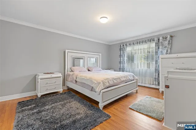 a bedroom with a white bed and white cabinets