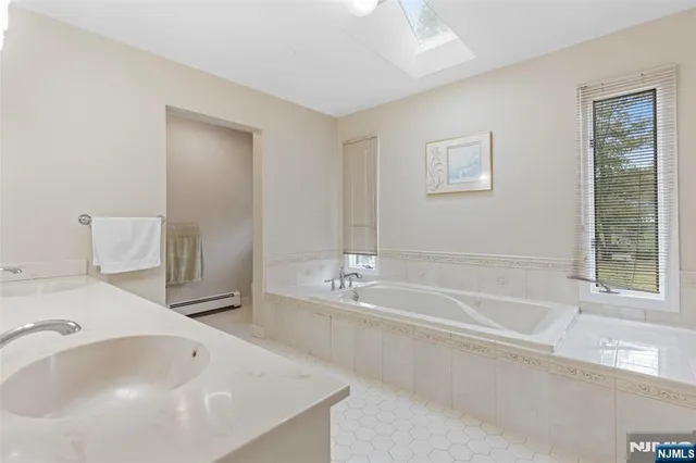 a bathroom with a bathtub and a sink