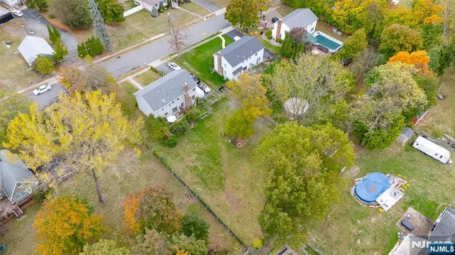 a aerial view of a residential houses with yard