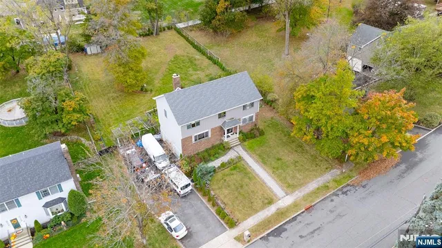 an aerial view of a house with a yard and lake view
