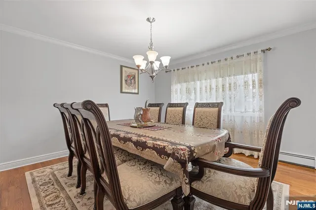 a view of a dining room with furniture and chandelier