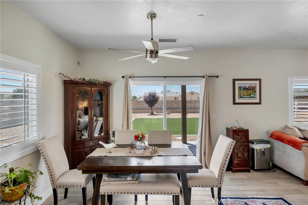13178 Setancket Road Apple Valley, CA 92308 - Photo 11 of 24 a view of a dining room with furniture window and outside view