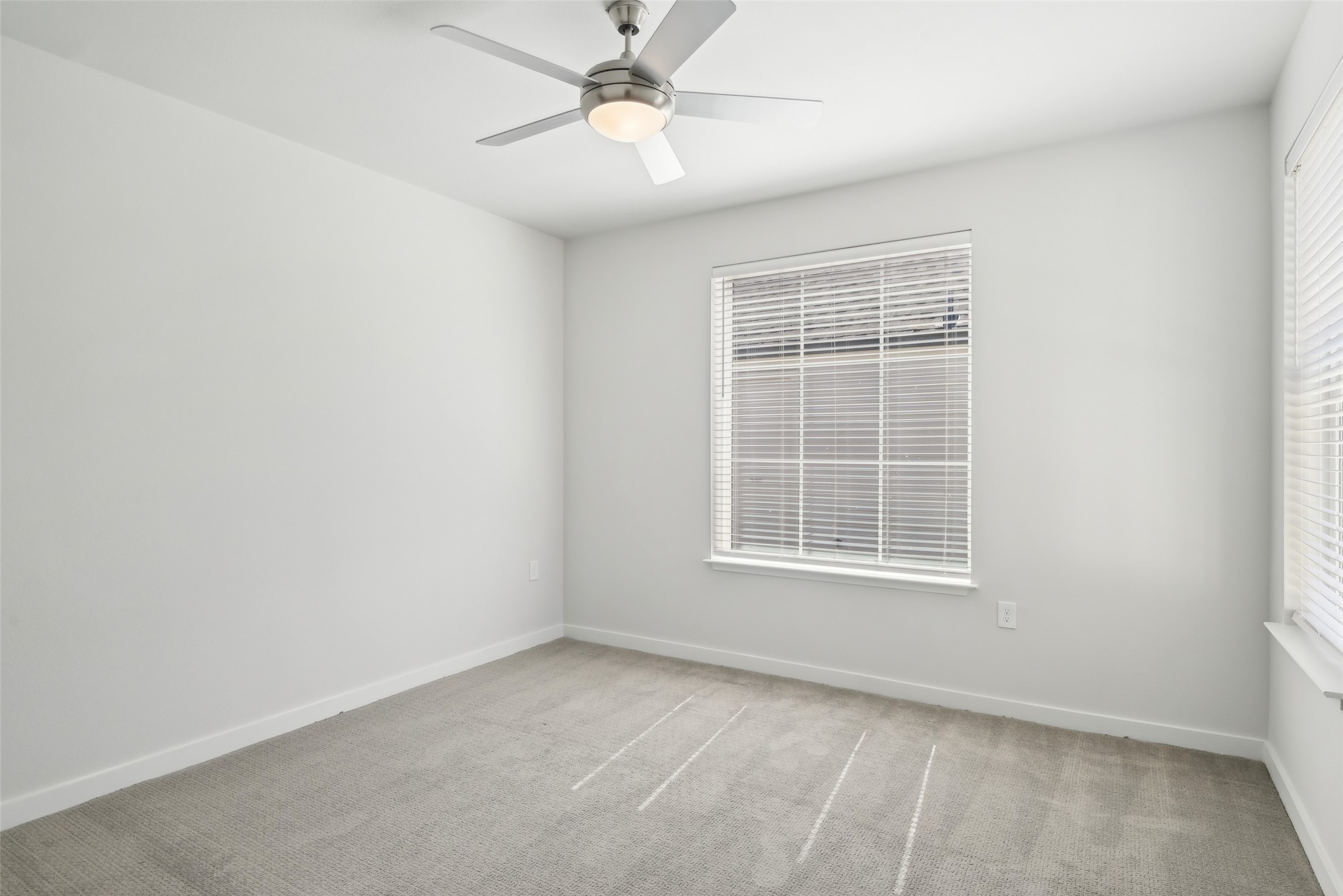 3651-205 South Custer Road McKinney, TX 75070 - Photo 12 of 25 an empty room with a window and a fan