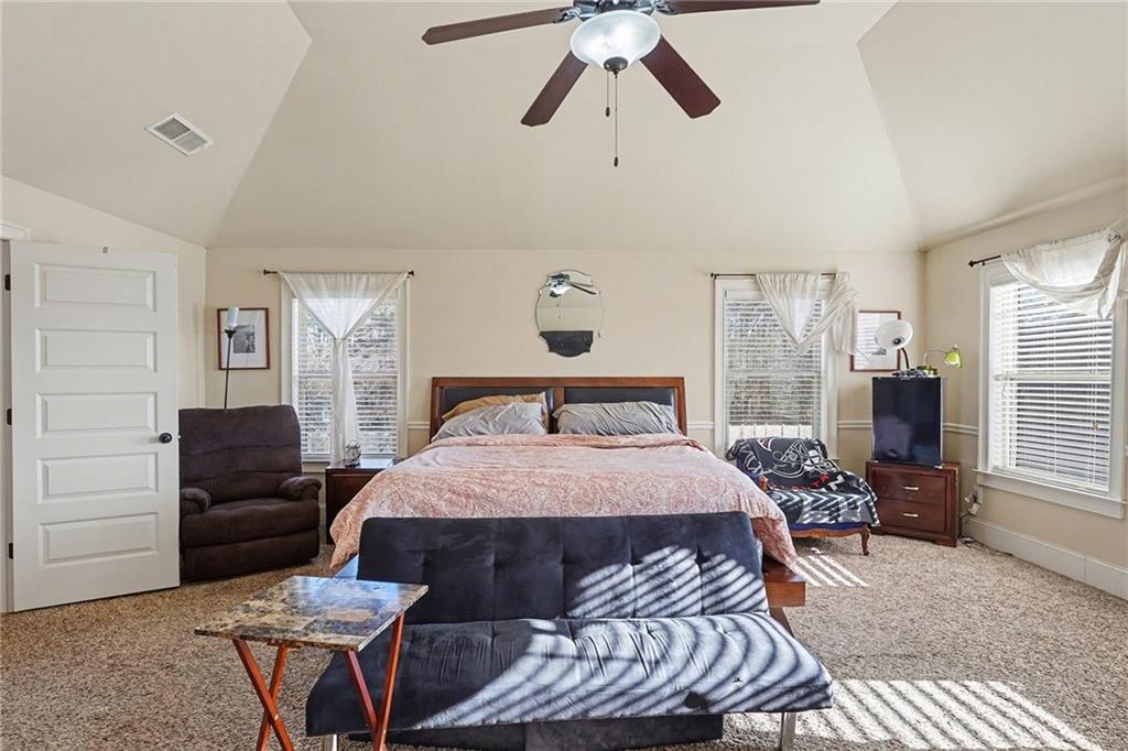 560 Aerial Avenue Stockbridge, GA 30281 - Photo 15 of 35 a bedroom with a bed and wooden floor