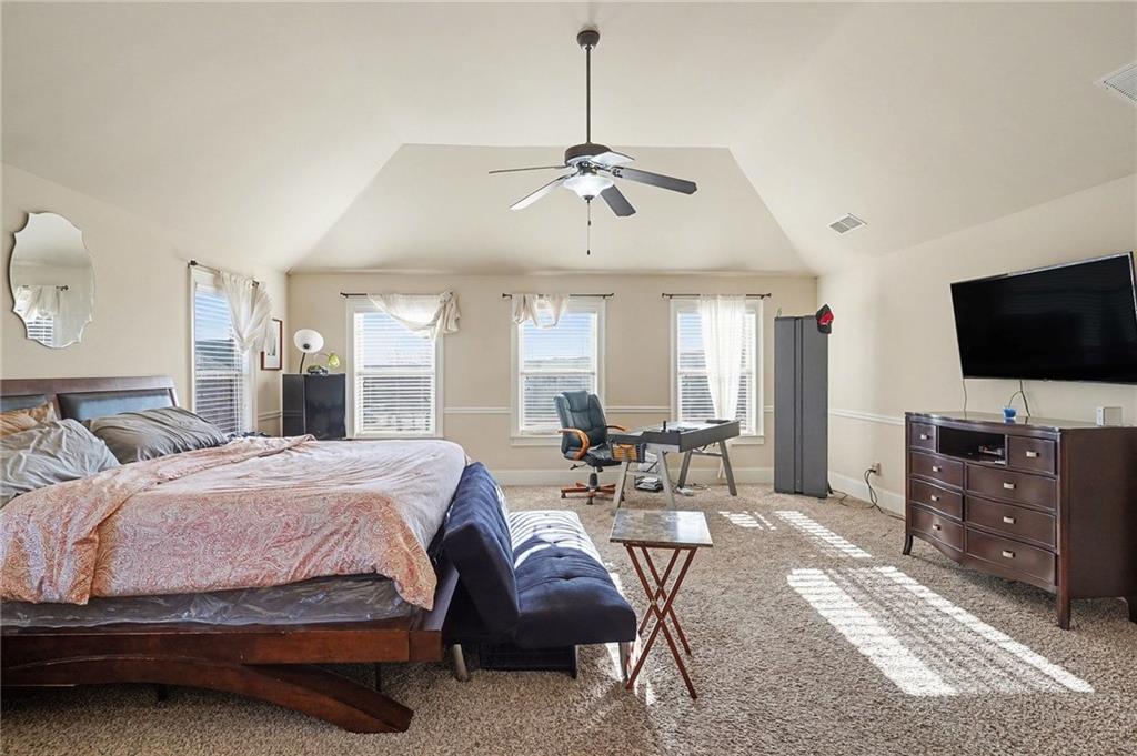 560 Aerial Avenue Stockbridge, GA 30281 - Photo 18 of 35 a bedroom with a bed window and flat screen tv