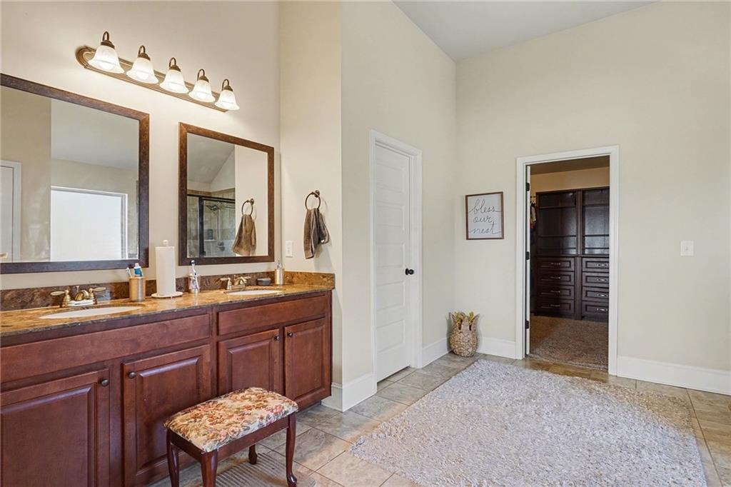560 Aerial Avenue Stockbridge, GA 30281 - Photo 19 of 35 a spacious bathroom with a granite countertop sink a mirror and a vanity