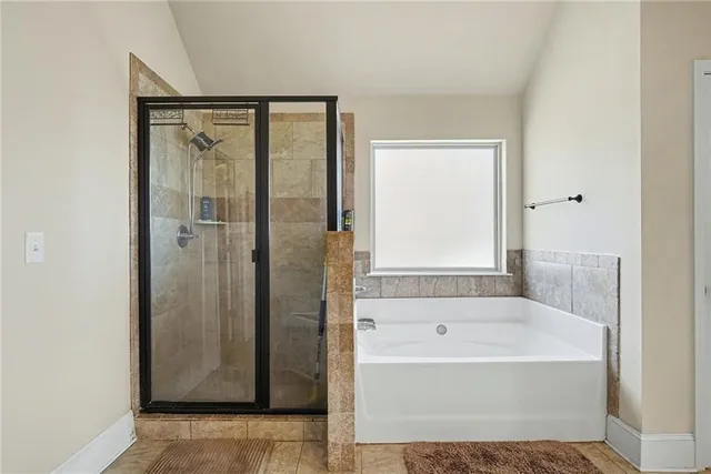 a bathroom with a bathtub and a shower