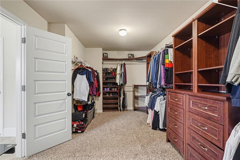 560 Aerial Avenue Stockbridge, GA 30281 - Photo 22 of 35 a view of walk in closet with clothes and shoes