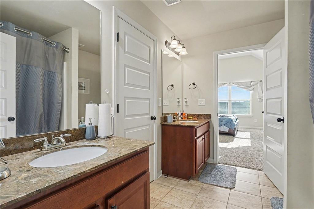 560 Aerial Avenue Stockbridge, GA 30281 - Photo 25 of 35 a spacious bathroom with a granite countertop sink a toilet a mirror and shower