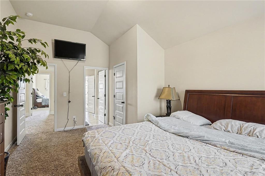 560 Aerial Avenue Stockbridge, GA 30281 - Photo 27 of 35 a bedroom with a bed and a flat screen tv