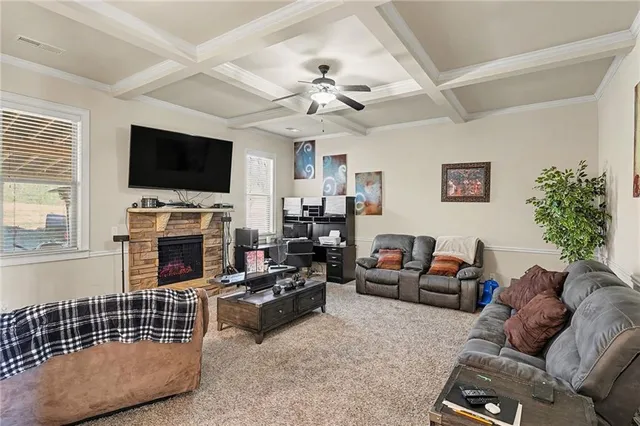 a living room with furniture a fireplace and a flat screen tv