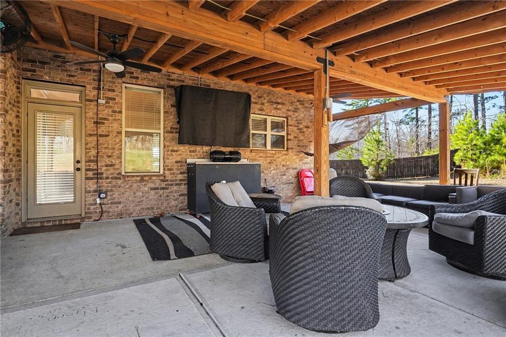 560 Aerial Avenue Stockbridge, GA 30281 - Photo 32 of 35 a outdoor living space with furniture and a potted plant