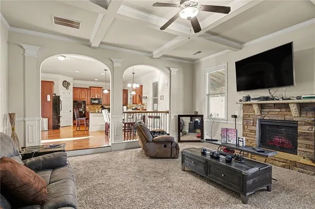 a living room with furniture a flat screen tv and a fireplace