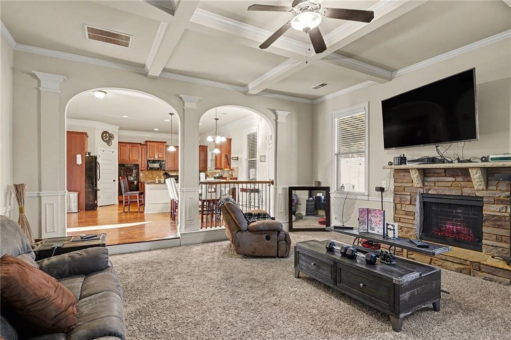 560 Aerial Avenue Stockbridge, GA 30281 - Photo 4 of 35 a living room with furniture a flat screen tv and a fireplace