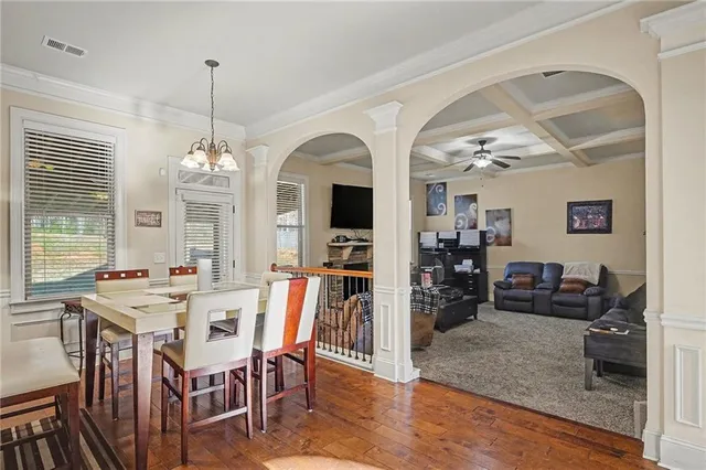 a view of a dining room with furniture and a chandelier
