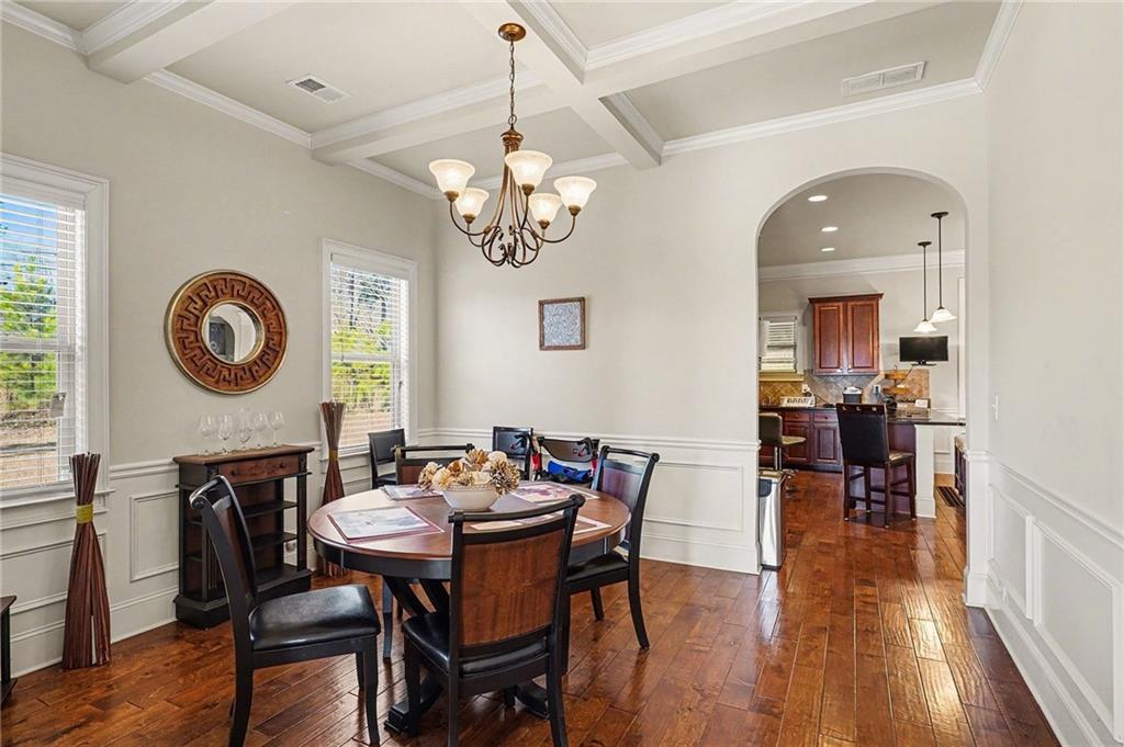 560 Aerial Avenue Stockbridge, GA 30281 - Photo 10 of 35 a view of a dining room with furniture a chandelier and wooden floor