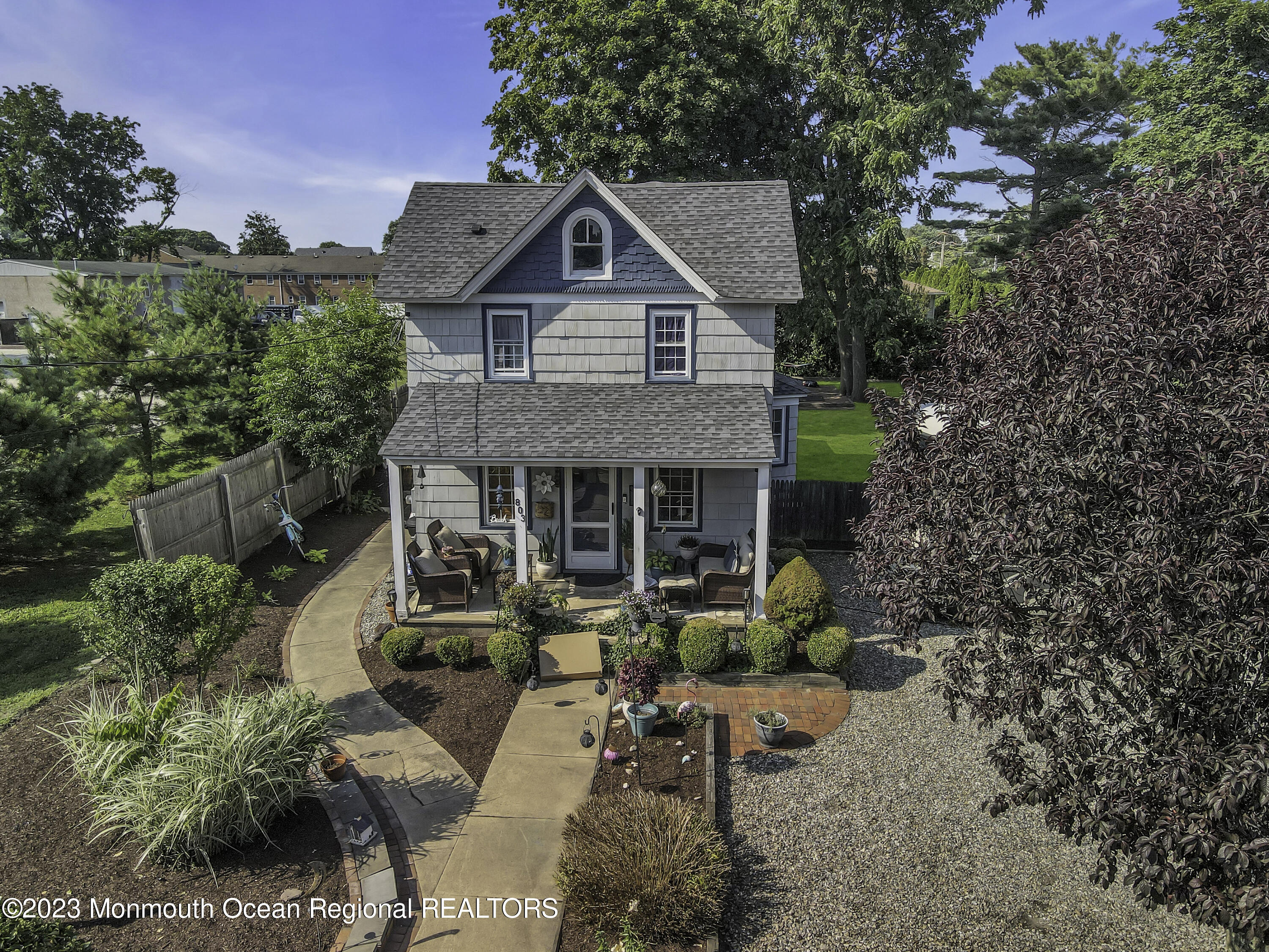 a front view of house with a garden and patio