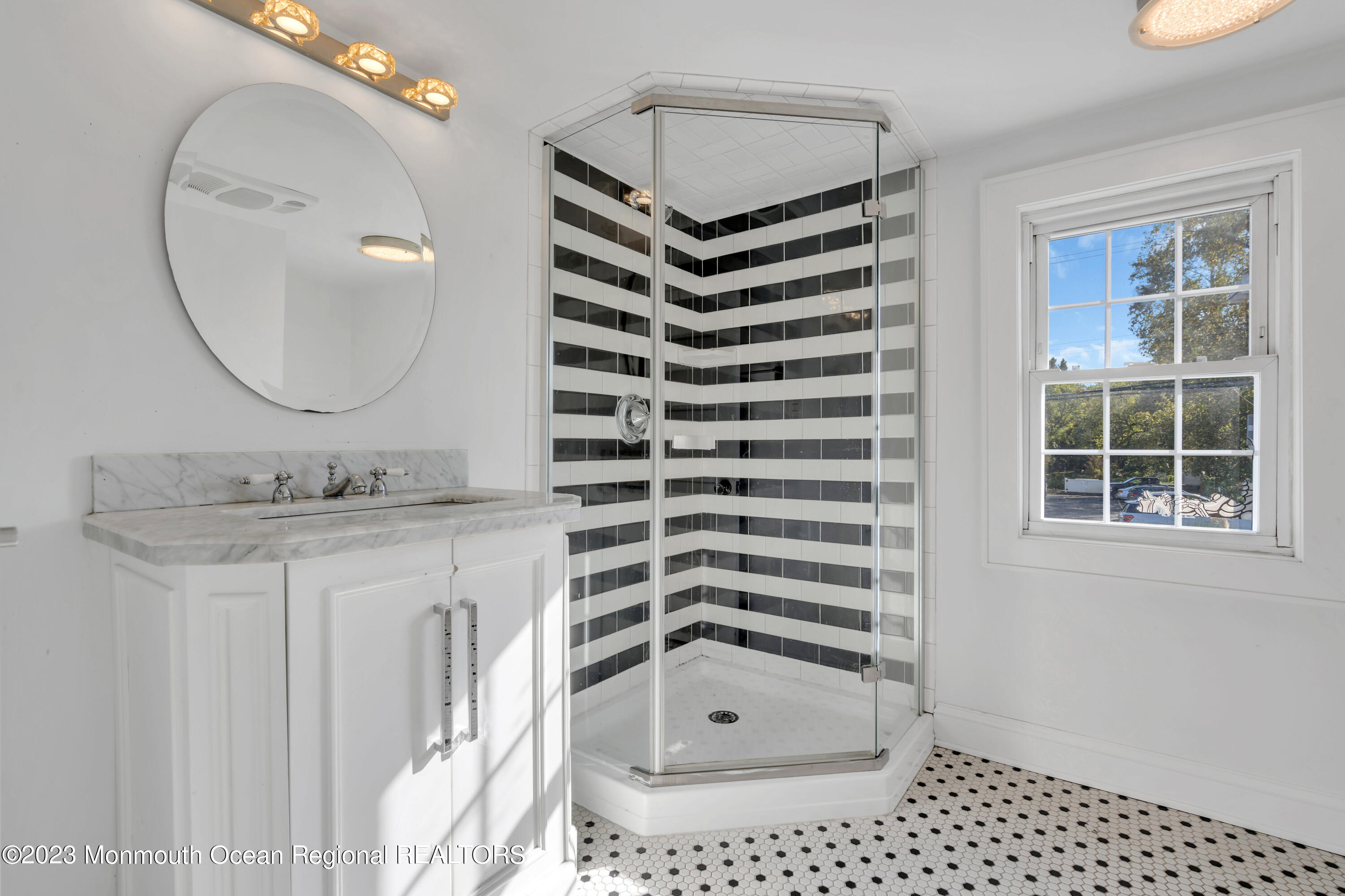 803 Ocean Road Point Pleasant, NJ 08742 - Photo 15 of 43 a bathroom with a sink a mirror and a shower