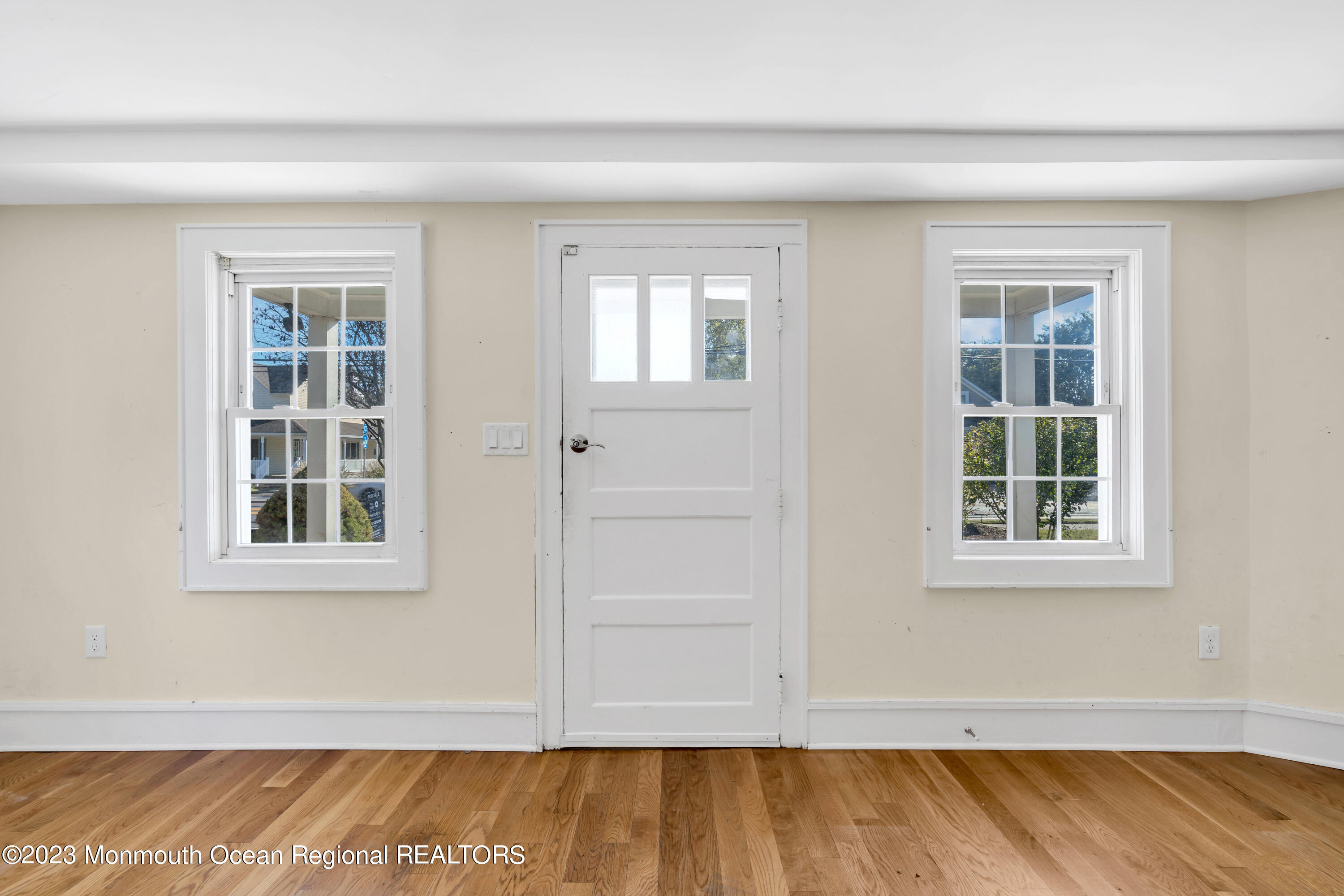 803 Ocean Road Point Pleasant, NJ 08742 - Photo 4 of 43 a view of an empty room with wooden floor and a window