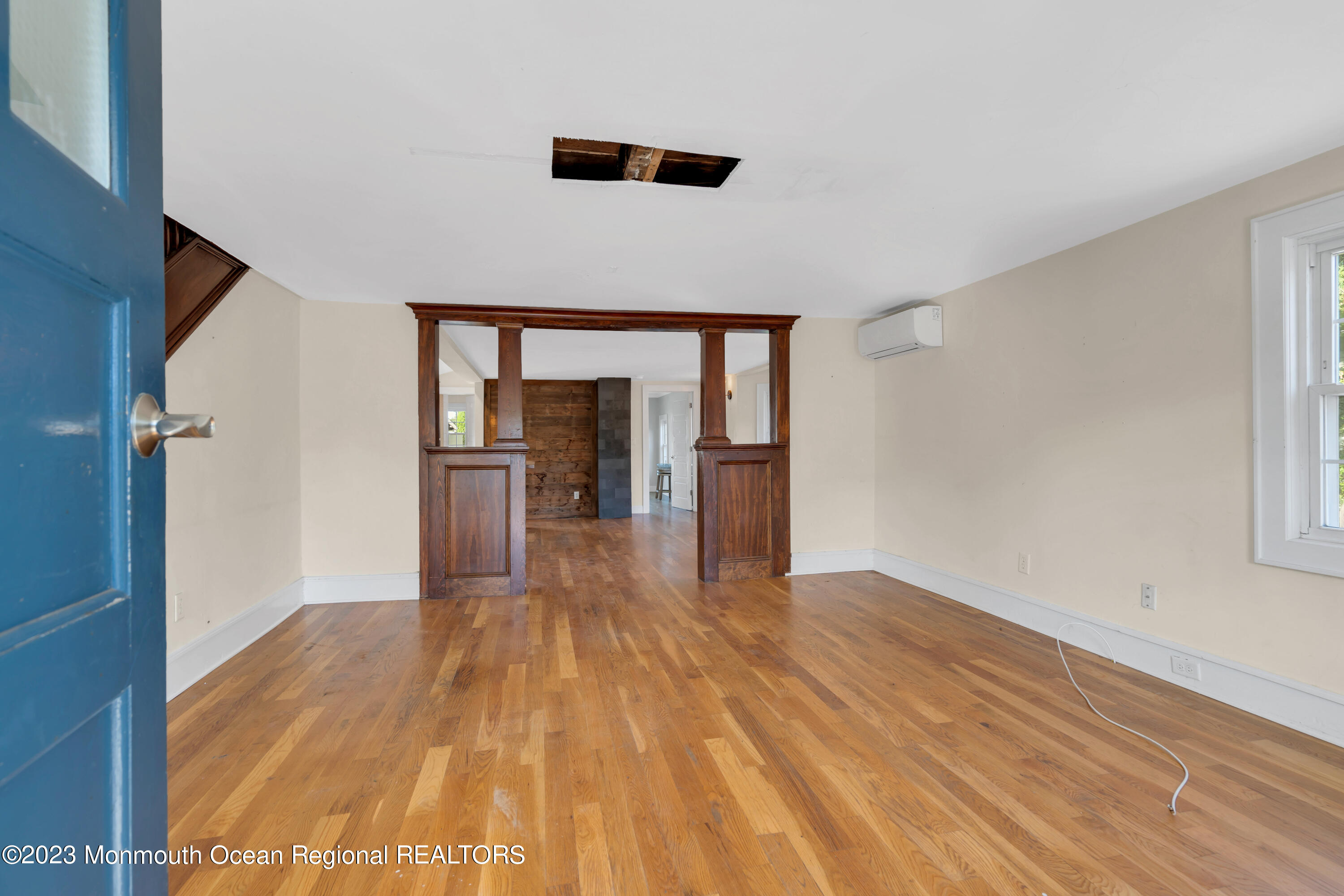 803 Ocean Road Point Pleasant, NJ 08742 - Photo 5 of 43 a view of empty room with wooden floor and kitchen