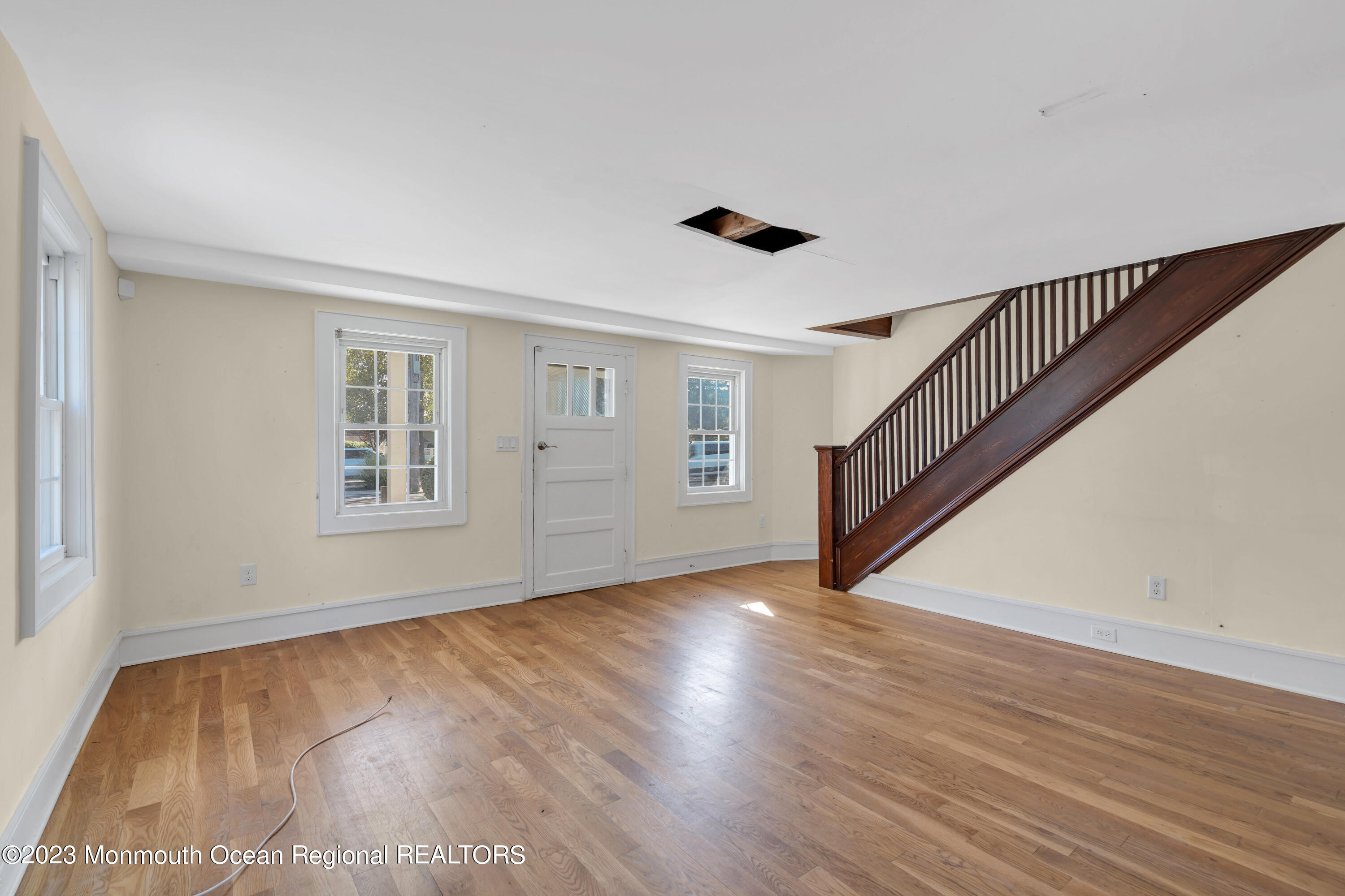 803 Ocean Road Point Pleasant, NJ 08742 - Photo 7 of 43 a view of an empty room with wooden floor and a window