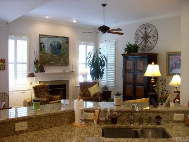 7335 Fontana Ridge Lane Raleigh, NC 27613 - Photo 12 of 12 a living room with furniture a chandelier and a fireplace