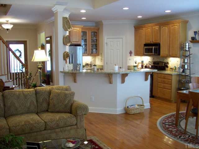 7335 Fontana Ridge Lane Raleigh, NC 27613 - Photo 5 of 12 a living room with furniture kitchen view and a wooden floor
