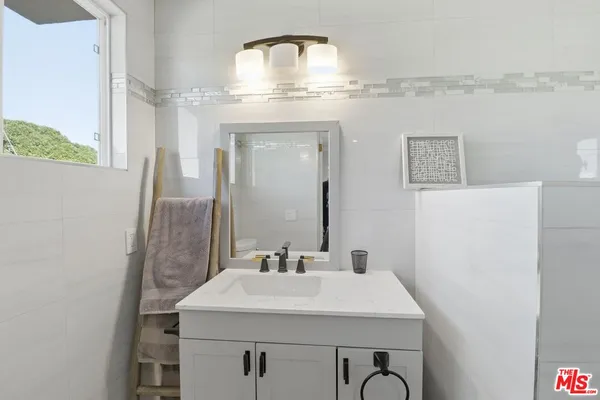 a kitchen with granite countertop a sink stove and cabinets