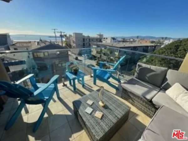 a terrace with outdoor seating and city view