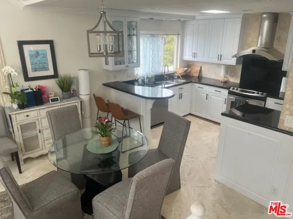 a living room with furniture and kitchen view
