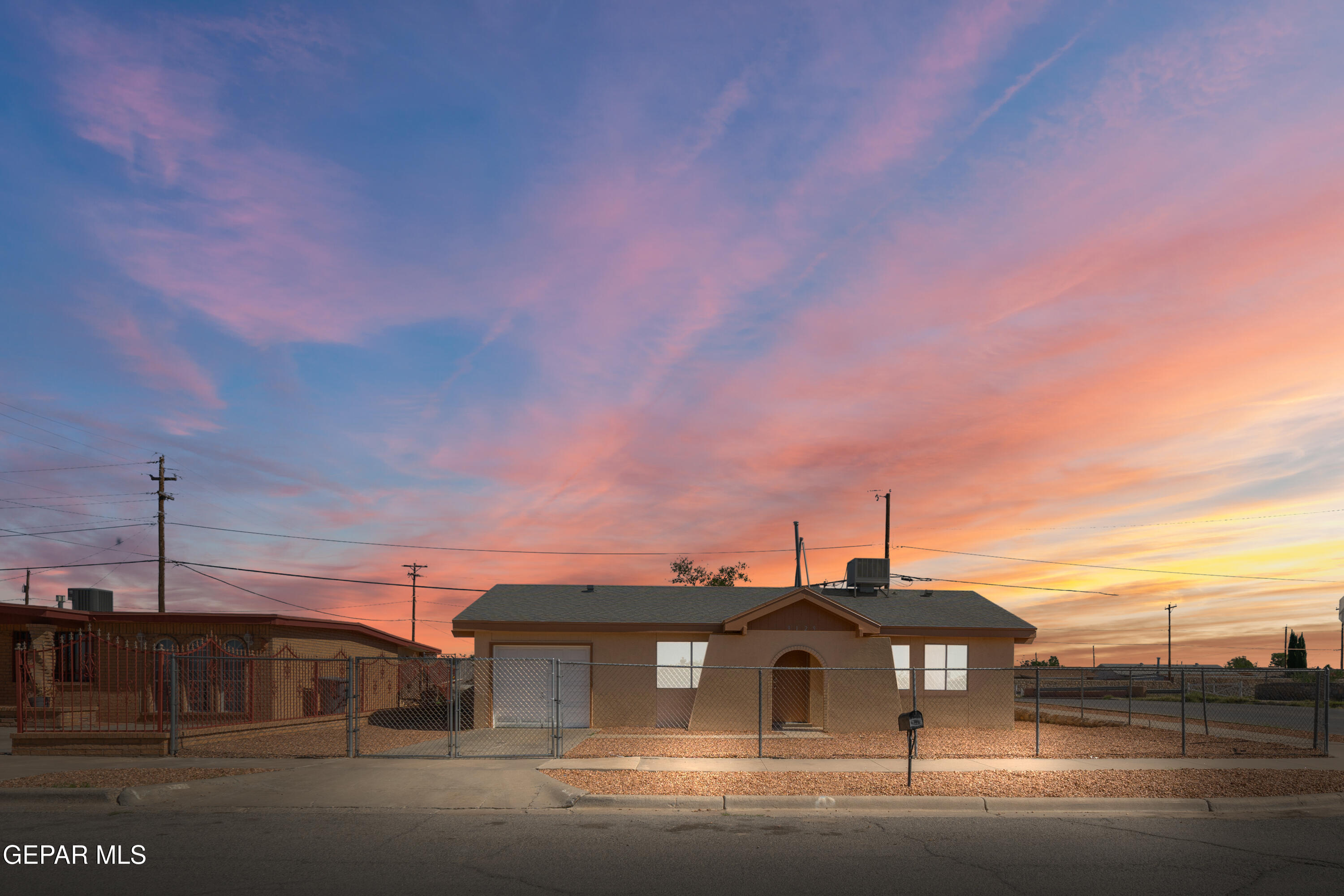 a front view of a house with a road