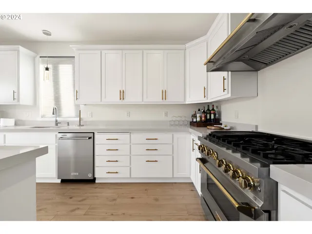 a kitchen with granite countertop a stove and cabinets