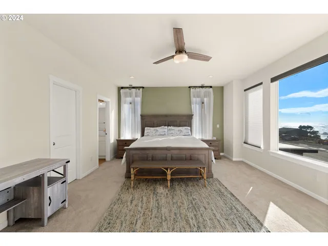 a bedroom with a bed and a view of kitchen