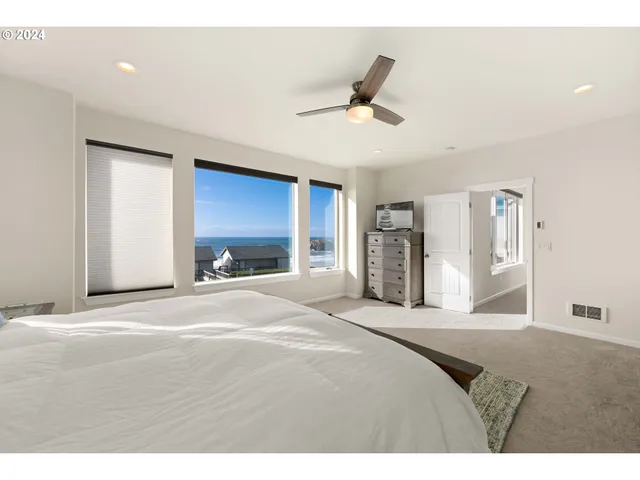 a bedroom with a bed and a large mirror