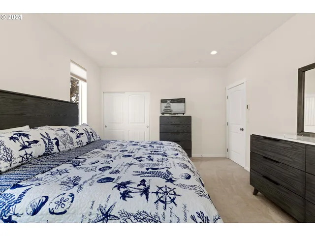 a bedroom with a large bed and a dresser