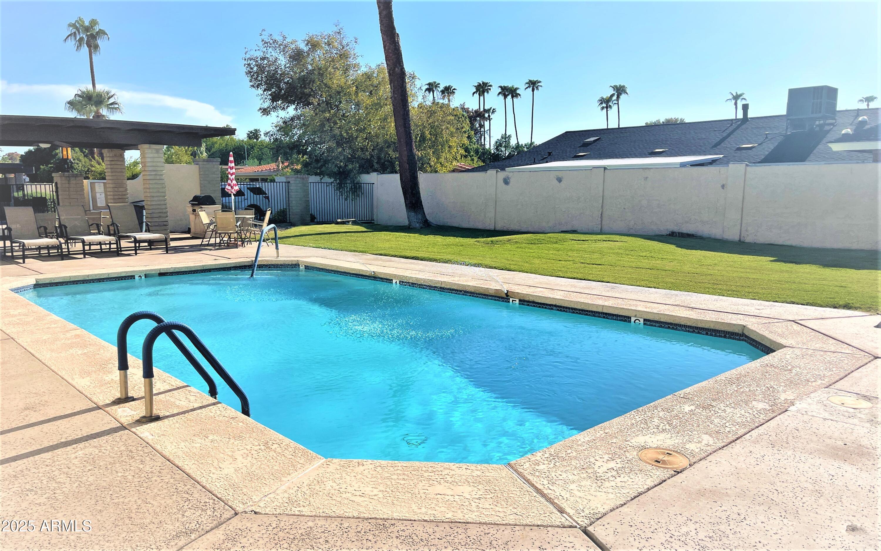 a view of a swimming pool with a lounge chairs